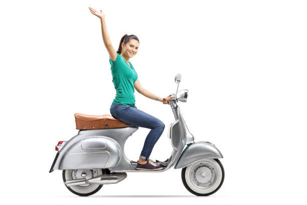 istock Young female riding a vintage scooter and waving 1077703102