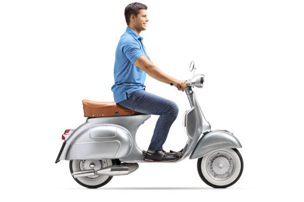 istock Smiling young man riding a vintage scooter 1077703390