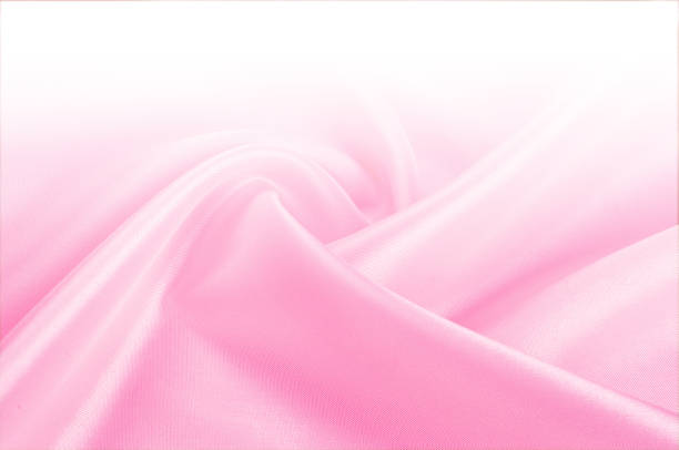 istock Texture, background, pattern. Light beige, pink shades of silk fabric, text space. Pink silk background based on natural texture 1077704642