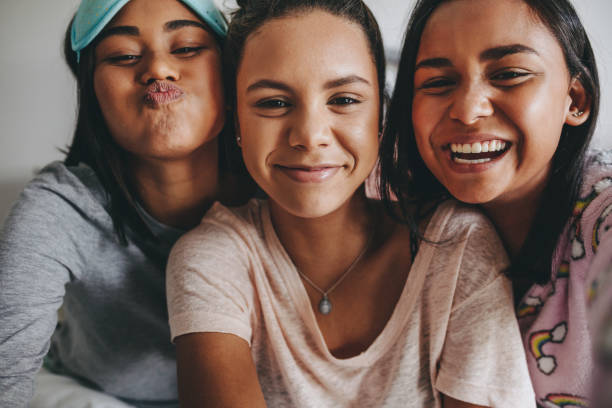 istock Girls having fun smiling and making faces for a selfie 1077708232