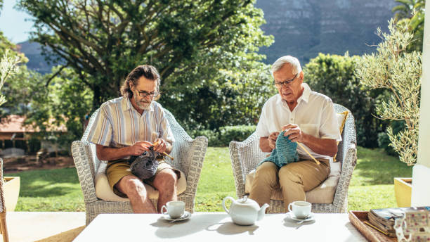 istock Two old men knitting in patio 1077711154
