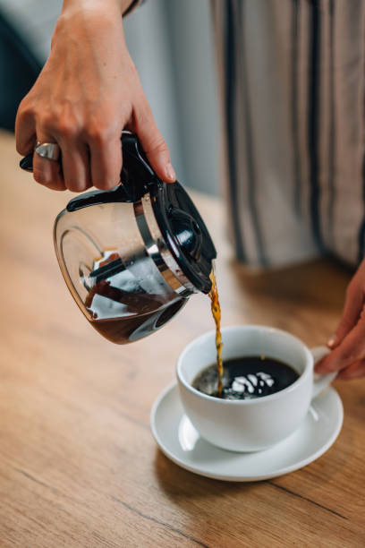 istock Midsection Of Woman Holding Coffee Maker 1077711972