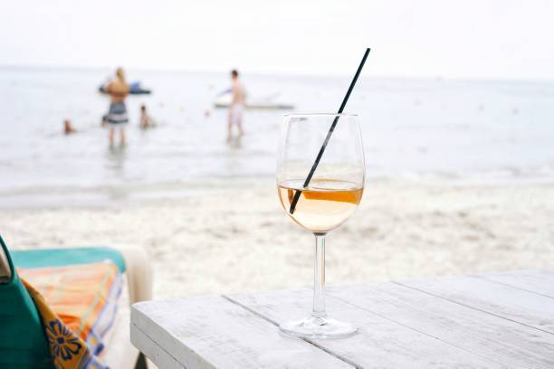 istock Wine Glass On Table At Beach 1077714654