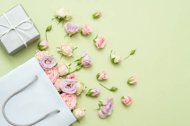 istock paper bag roses green background silver gift box 1077723742