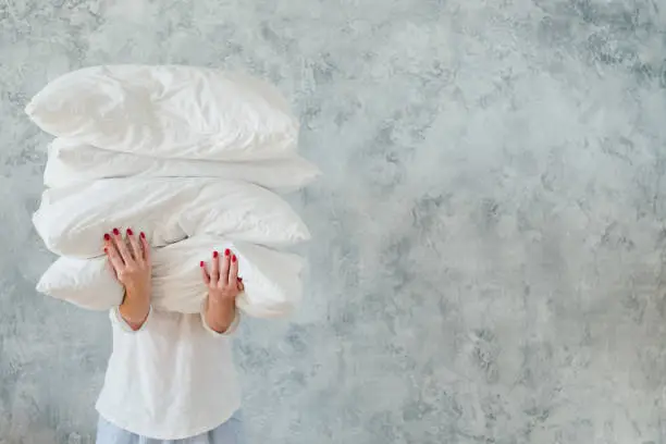 Photo of woman hold pile white pillows bedding sleeping