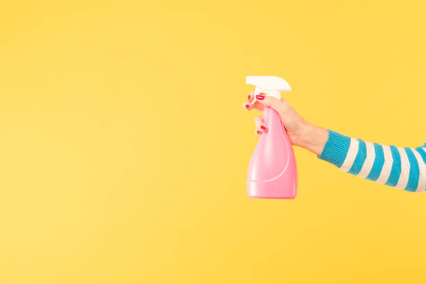 istock female hand hold sprayer yellow cleaning housework 1077723890