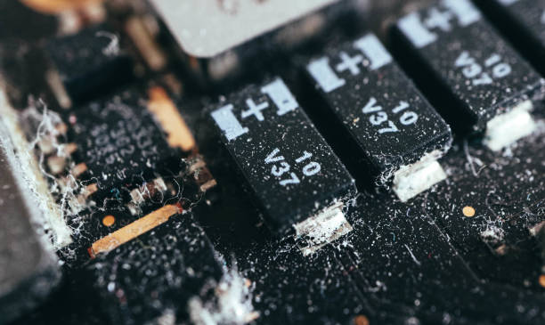 istock An abstract dusty computer motherboard, macro view. Old computer, needs cleaning and repair concept. 1077737924