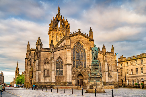 Stock photograph of the landmark St. Giles Cathedral and the statue of St Giles in old town Edinburgh Scotland UK at sunset.