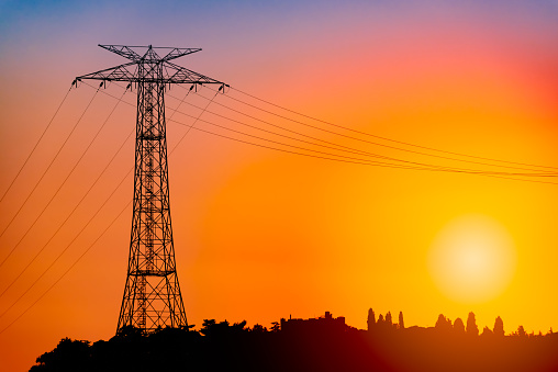 Power grid pylon against orange sunset sky in Istanbul, Turkey