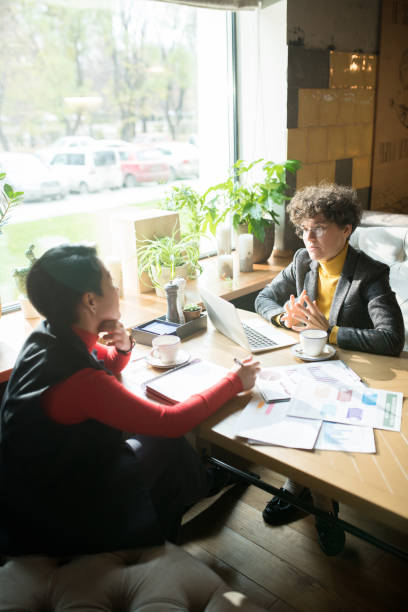 istock Discussing business charts in cafe 1077743072