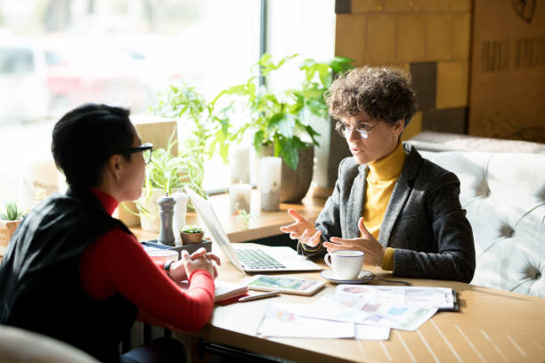 istock Confident female business analyst sharing report results with co 1077743094