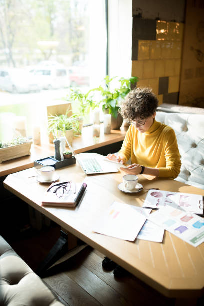 istock Concentrated business lady using gadget 1077743124