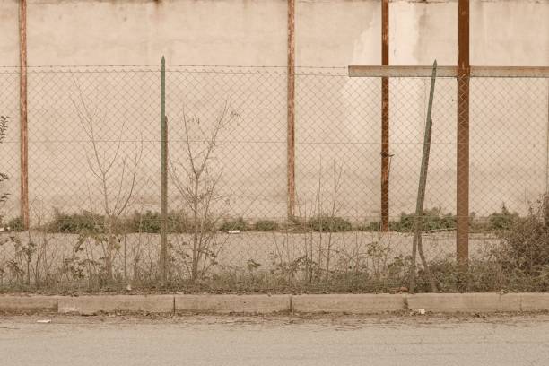 istock Metallic fence of an abandoned building (Pesaro, Italy, Europe) 1077743368
