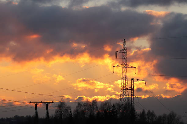 High voltage electric lines cross the hilly mestnost. Electric station in the summer under the open sky. Power industry. Ecology of nature. Metal technological structures. Strategic object in sunset las líneas eléctricas de alta tensión cruzan el mestnost montañoso. estación eléctrica en el verano bajo el cielo abierto. industria de la energía. ecología de la naturaleza. metal estructuras tecnológicas. objeto estratégico en la puesta de sol