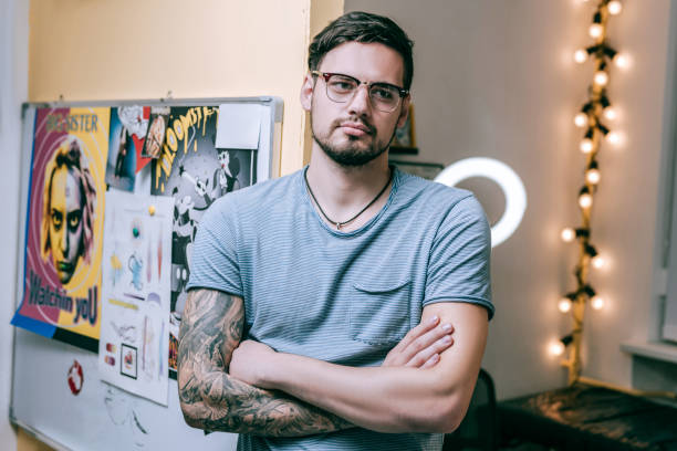 istock Handsome short-haired guy visiting tattoo master and waiting for his session 1077744116