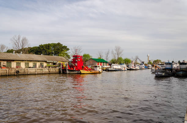 istock River dock with boats on a day with clouds 1077744134