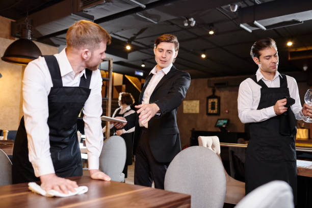 istock Restaurant manager giving task to waiter during cleanup 1077746424