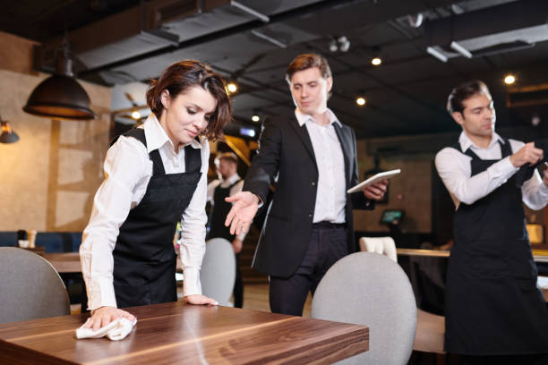 istock Handsome manager giving recommendations about cleanup to waitres 1077746428