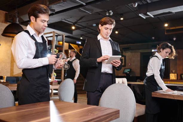 istock Concentrated restaurant manager checking online records on table 1077746430