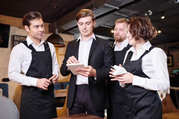 istock Serious restaurant manager dividing responsibilities among waite 1077746444