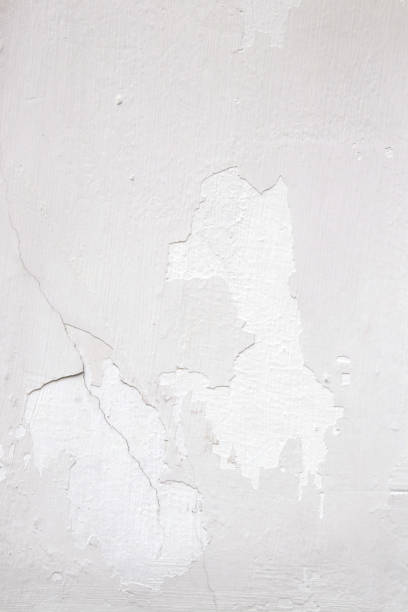 istock Light wall with white paint peeling off texture in grey and white tone. Copy space. Background for design. 1077748272