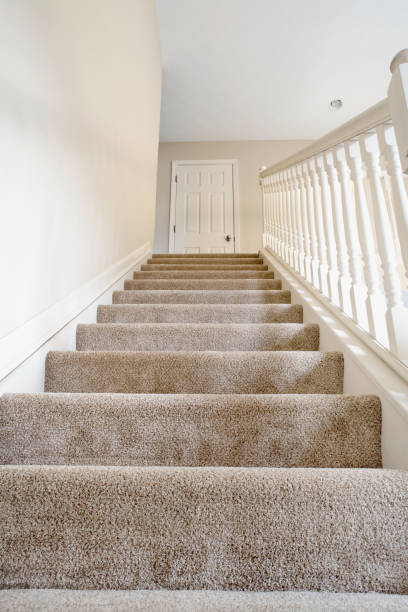 istock Ascending Carpeted Open Staircase in Neutral Colors 1077748372