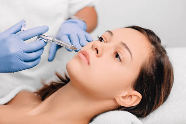 istock woman having lip injections, procedure lip augmentation 1077751234