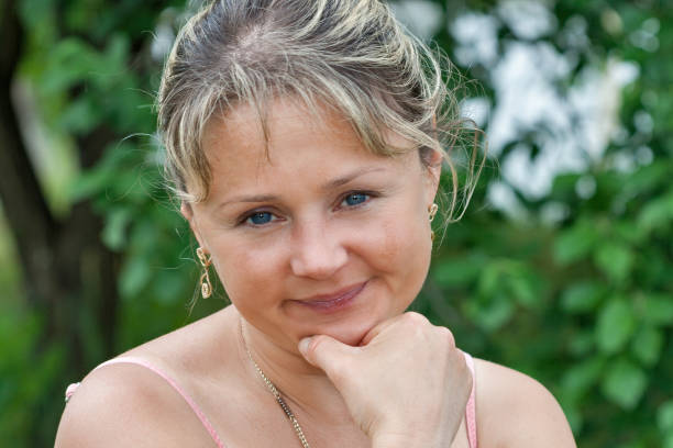 istock Happy woman portrait with nature background 1077754914
