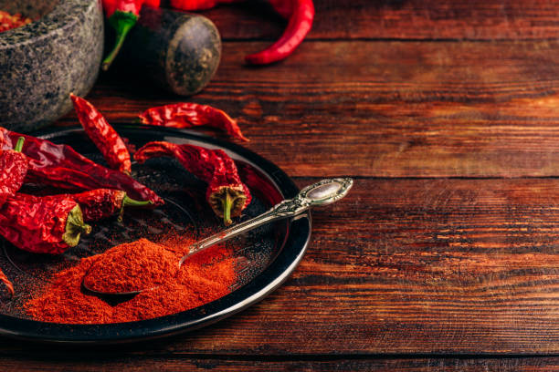 istock Ground and dried chili peppers on metal plate 1077754966