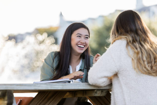 istock Happy female college student talks with friend 1077757950