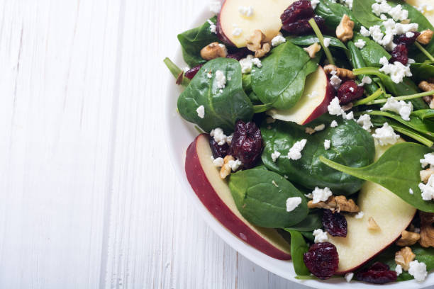 istock Autumn spinach salad with apple , cheese , walnut and dried cranberry . Healthy vegetarian food 1077758564
