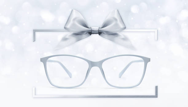 istock eyeglasses gift card, grey spectacles and silver ribbon bow in box frame isolated on blurred lights  background 1077761052