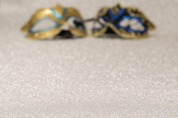 istock two carnival masks on a gray background out of focus 1077761374