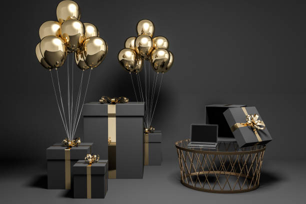istock Black presents with gold balloons and laptop 1077763208