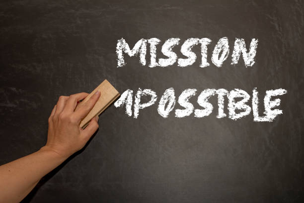 hand changing the word impossible to possible. Alphabet I, M being erased from a chalkboard. Change concept. hand changing the word impossible to possible. Alphabet I, M being erased from a chalkboard. Change concept. possible stock pictures, royalty-free photos & images