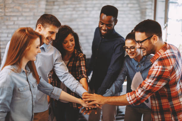 istock Young people showing team spirit focus on hands 1077770442