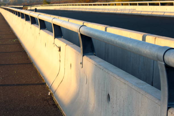 istock Concrete road bridge barrier with metal guard rails 1077772034