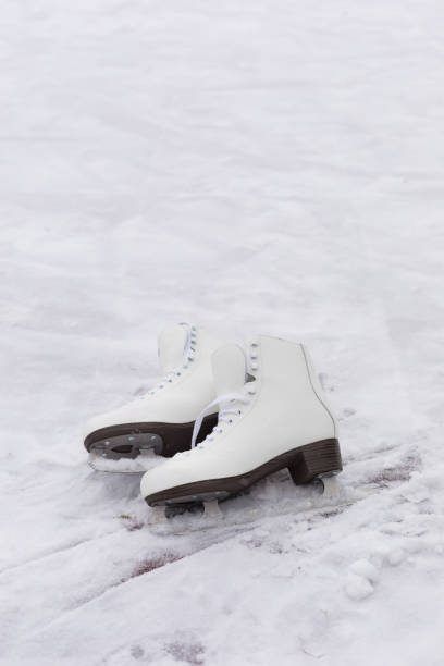istock Pair of White Ice Skates in snow 1077773006