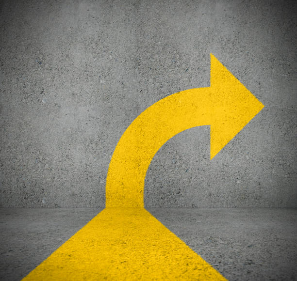 istock Single yellow arrow on wall turning right 1077782184