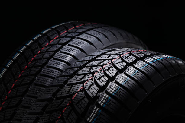 istock Winter Car tires on black background 1077786200