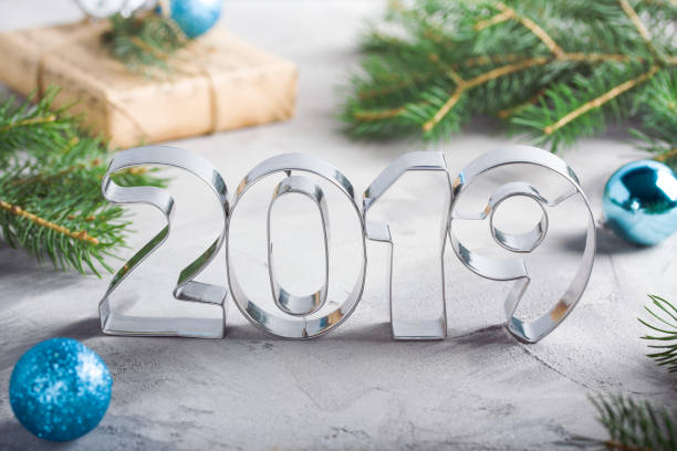 istock Happy New Year 2019 composition metallic letters balls fir-tree 1077788148