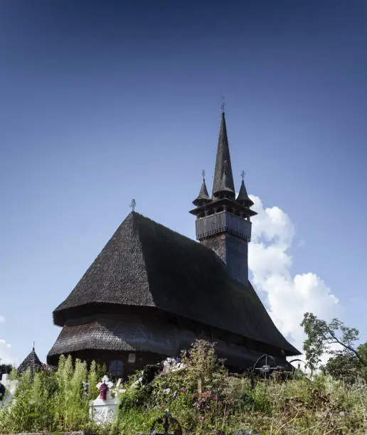Photo of Beautiful old medieval small wooden church in Budesti, Romania.