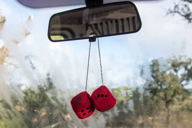 Dice hanging from rear view mirror stock photo
