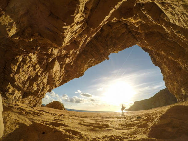 istock Surfer walking away into the sun 1077797592
