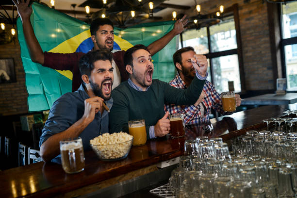 istock Friends in bar watching game 1077798006