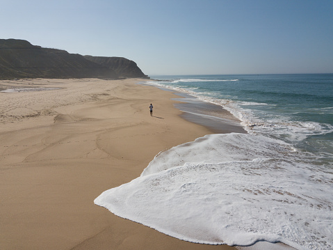 Footprints behind a man washed away by the sea