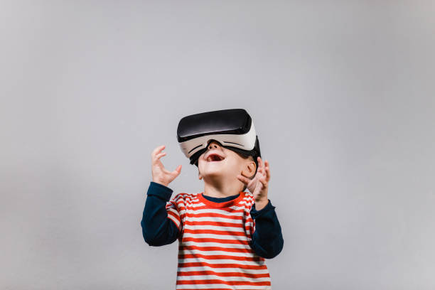Excited kid having fun with VR glasses. stock photo