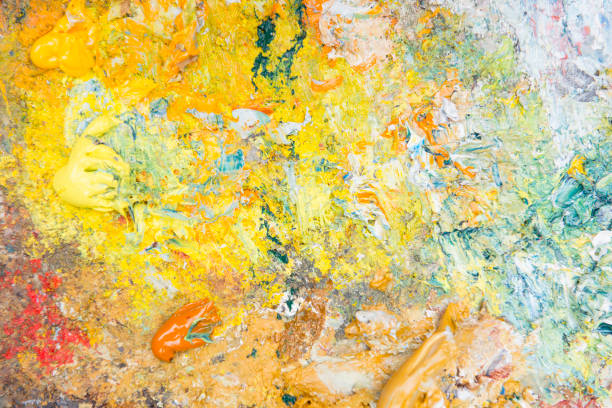 Close up of a palette with mixed colorful oil paintings