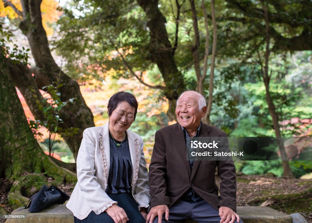 Happy senior couple taking a break in forest Senior Adult Stock Photo