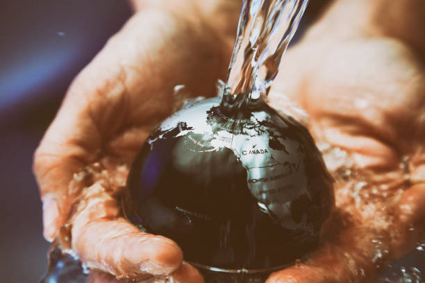 istock Water pouring on planet earth 1077815144